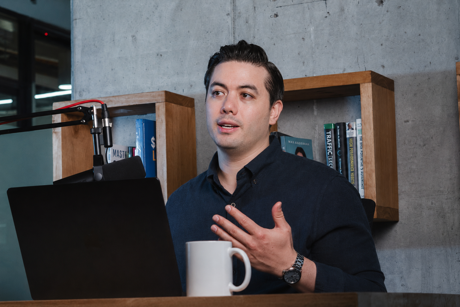 Reno recording a podcast at his desk